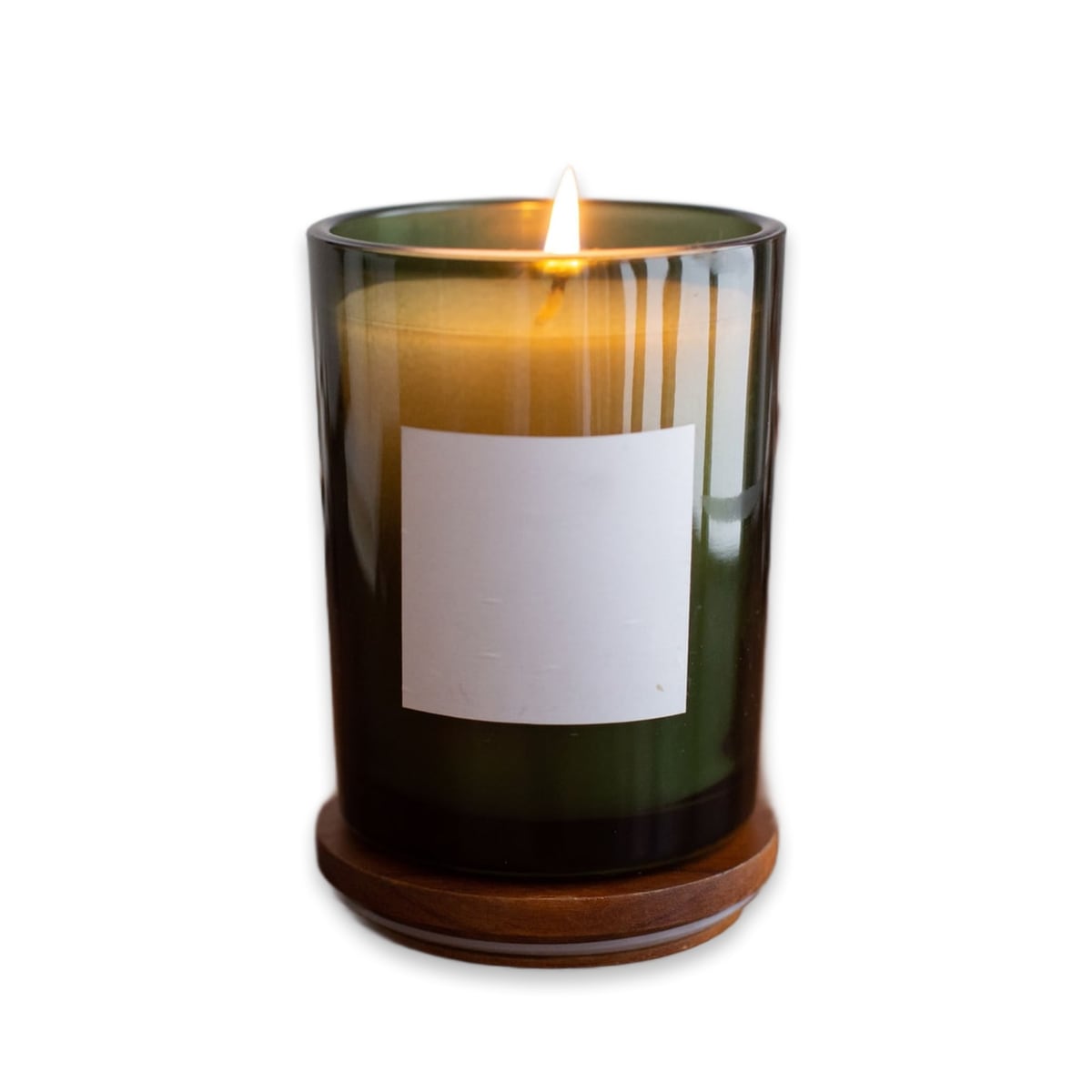 Candle in green glass, clean studio scene