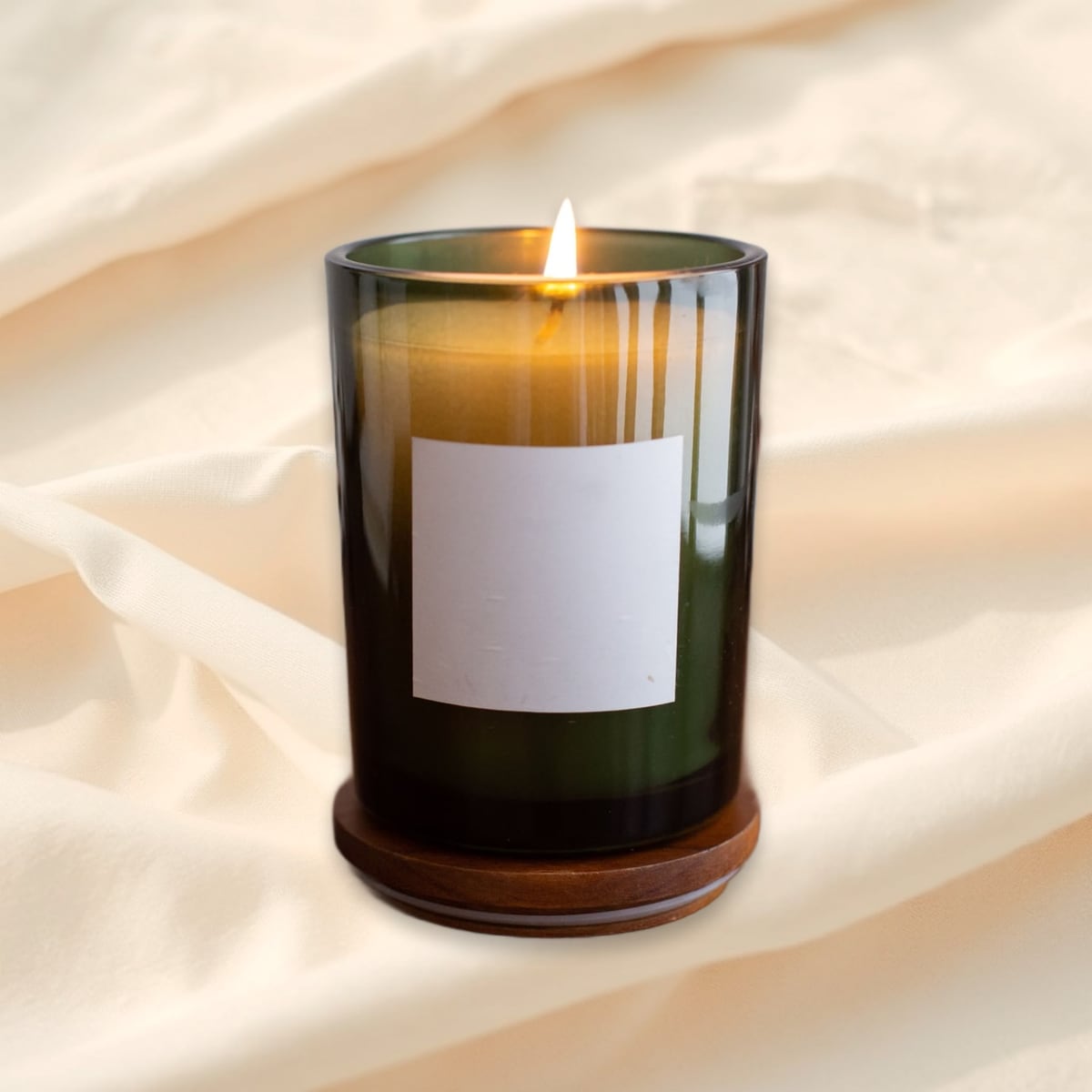 Candle in green glass, linen scene