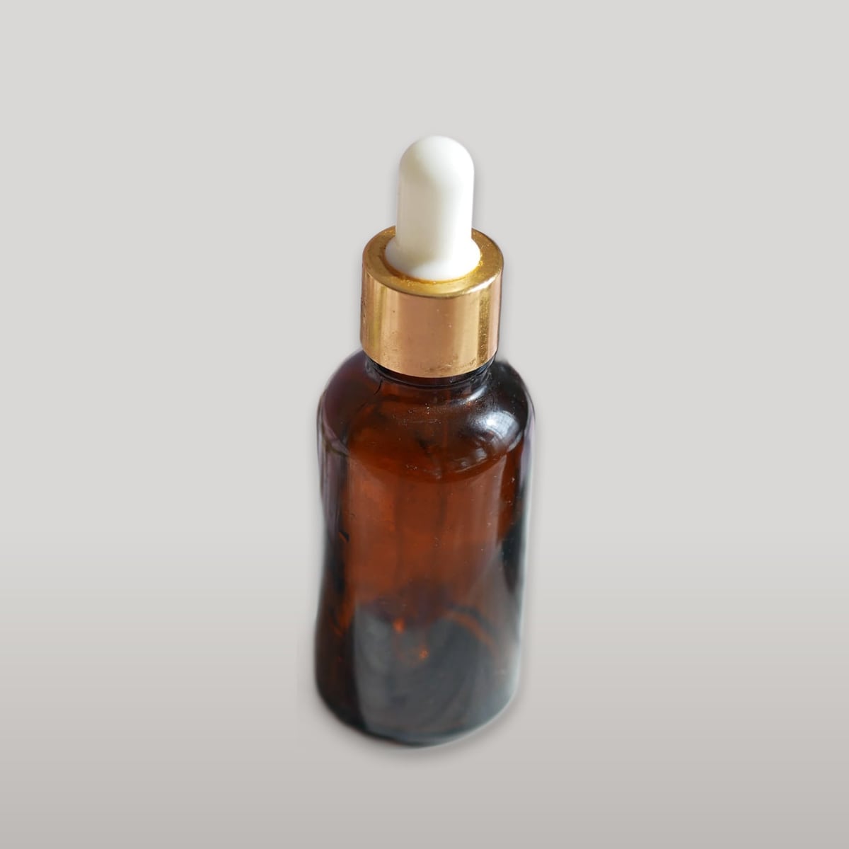 Amber serum bottle, studio tone scene